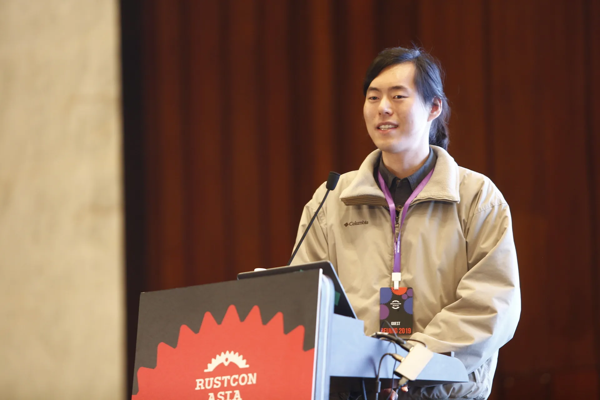 I was standing behind a podium that said "RustCon Asia" with a sign that said "Guest Beijing 2019"